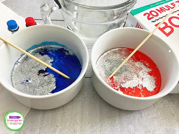 Mix in blue food coloring to one bowl and red to the other bowl. Add glitter and stir to combine.