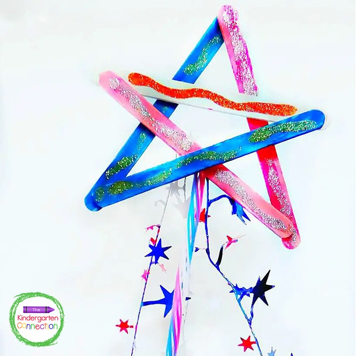 The glitter glue adds some fun sparkle to the patriotic star wand craft!