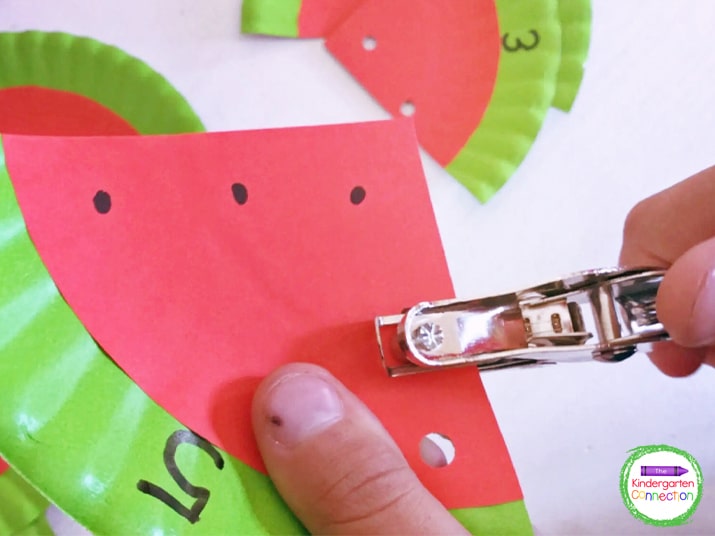Once the counting activity cards are ready, the kids can pick a watermelon card and punch out each "seed" while counting.