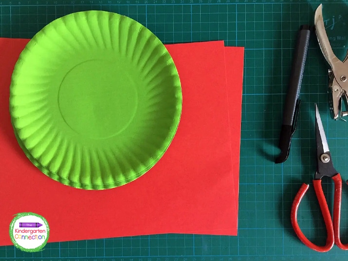 For this counting activity, you will need green paper plates, red paper, scissors, a hole punch, glue, and a marker.
