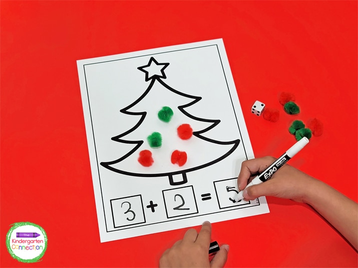 Students will roll a die to determine which numbers to write and add on the Christmas tree math mat.