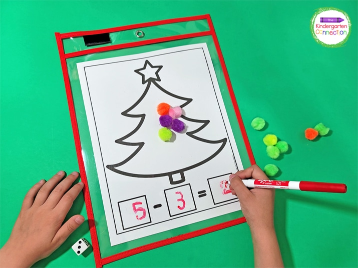 Students will roll a die to determine which numbers to write and subtract on the Christmas tree math mat.