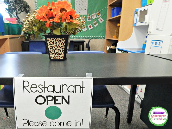 We use tape to hang our "OPEN" sign in the classroom so the other kids know that the restaurant is open for business.
