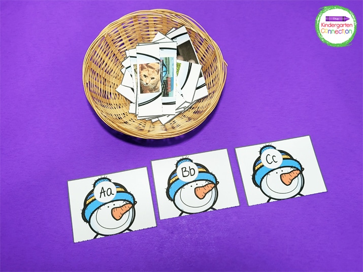 Place the snowman body cards in a small basket and spread the snowman head cards out on a flat surface.