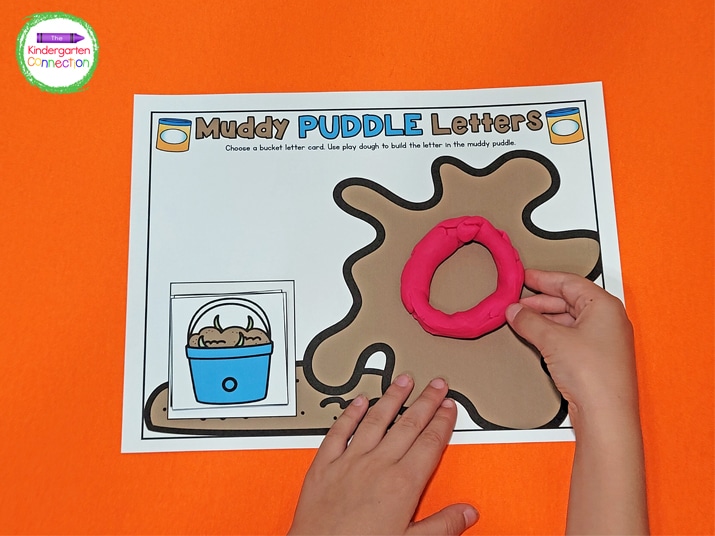 For this Muddy Puddle Letters activity, choose a bucket letter card and use play dough to build the letter.