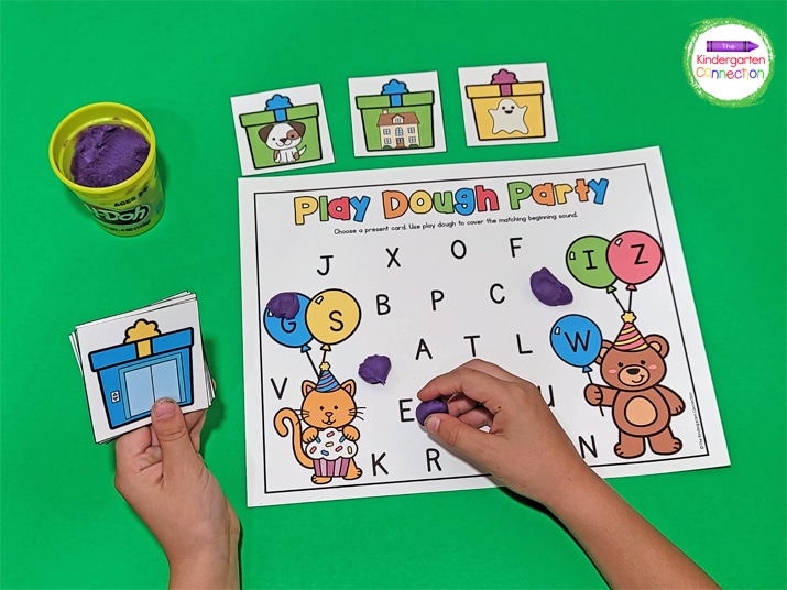 In Play Dough Party, choose a present card and use a play dough ball to smash the matching beginning sound on the mat. 