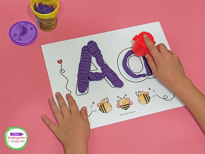 Play Dough tools can be used to 'smash' the play dough into the bubble letters, creating various textures on the letters.