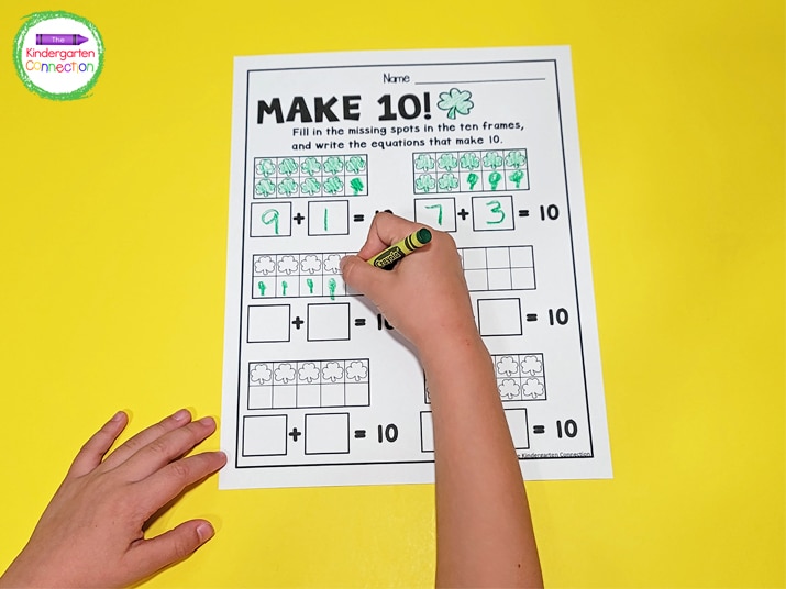 We use fun coloring tools like crayons to draw shamrocks in the ten frames and write our equations.