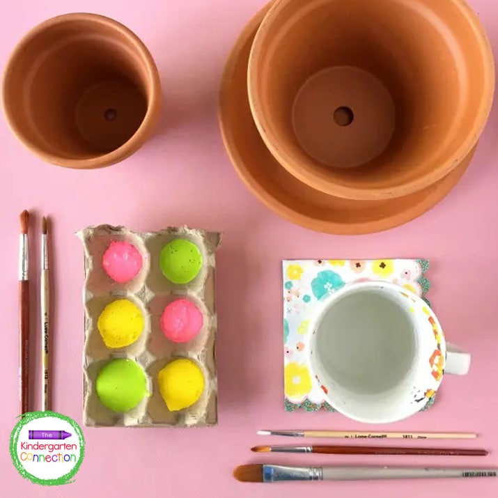 For this DIY bird bath, you need terra cotta pots, acrylic paints, and paint brushes.