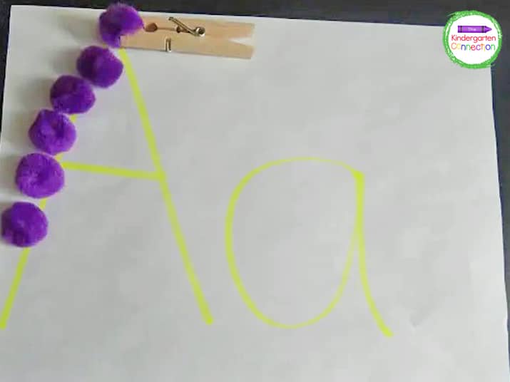 Use a clothespin and pom poms to combine fine motor and alphabet practice.