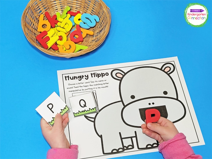 To play Hungry Hippo, kids choose a letter card , say its name, then feed the hippo the matching letter manipulative.