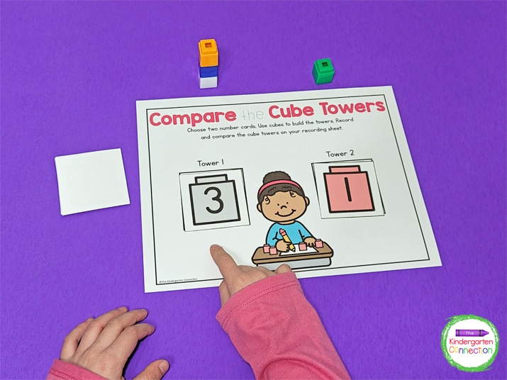 Students start by picking two cube number cards, placing them on the activity mat, and building their towers.