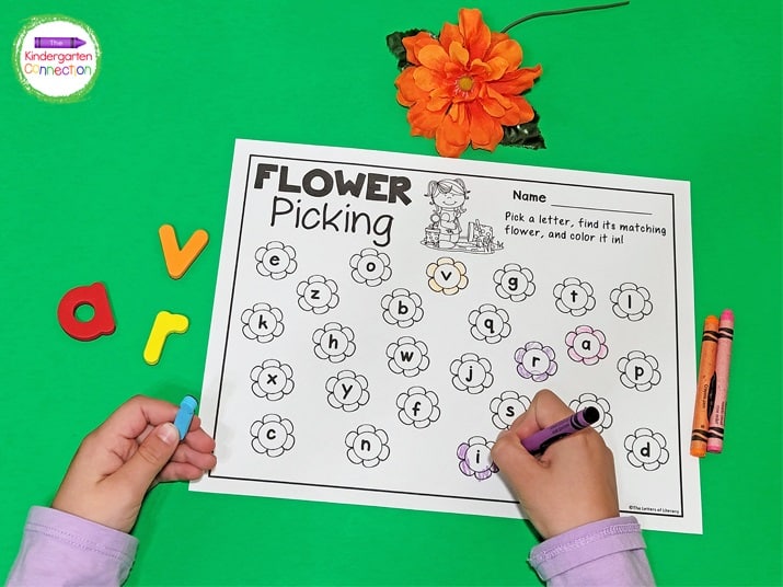 As the letters were picked, the kids found the corresponding flower letter on the recording sheet and colored it in.