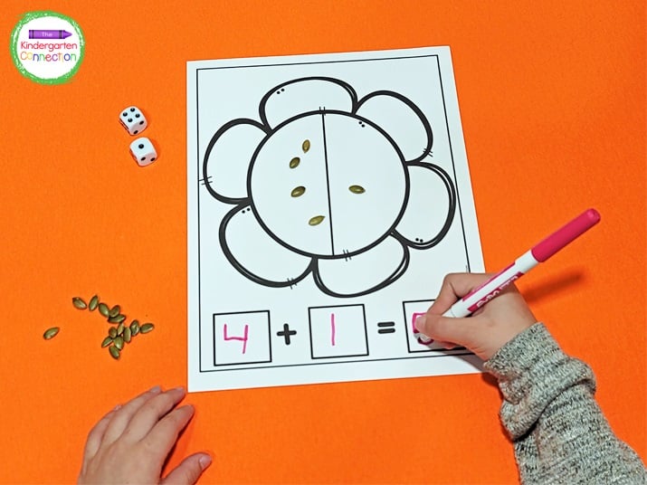 Students roll a die two times to find what two numbers to add. They can write the complete equation below the flower.