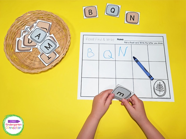 Kids choose a fossil letter card and write  the letter on the recording sheet.