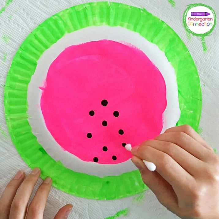 Invite your child to use a cotton swab dipped in black tempera paint to add the seeds.